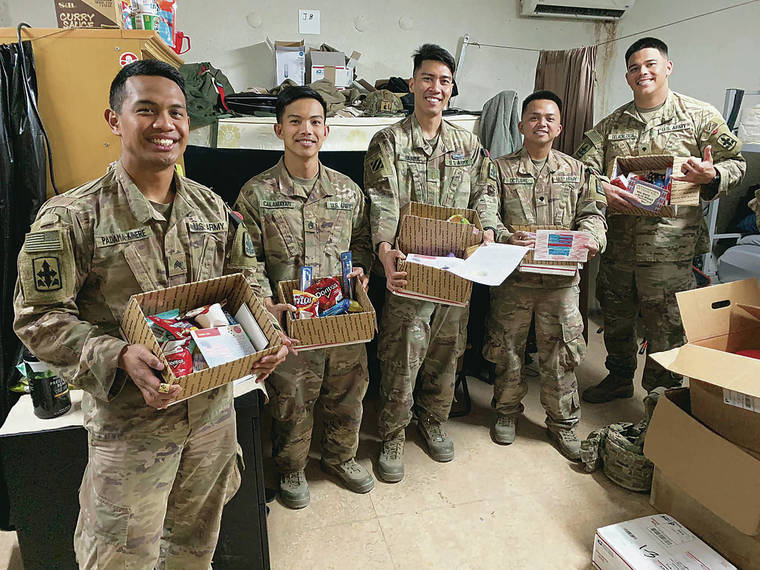 COURTESY PHOTO
                                Hawaii National Guard soldiers Sgt. Bradley Padama-Kinere, left, Staff Sgt. Paul Calamayan, 2nd Lt. Francisco Barba, Spc. Andrew Octubre and Spc. Shaun Dela Calzada show care packages they received. They are with the C-RAM mission in Uruzgan province in Afghanistan.
