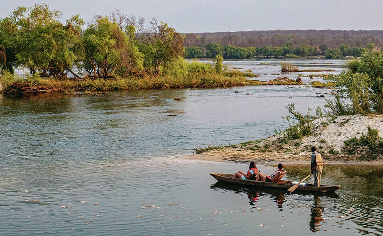 TRIBUNE NEWS SERVICE
                                It’s a creek, it’s a lake, no, it’s the super Zambezi River, calm enough above Victoria Falls for Siankaba Resort guests to take in a leisurely mokoro (canoe) ride among the islands of Siankaba resort, on the Zambezi River, Livingston, Zambia.