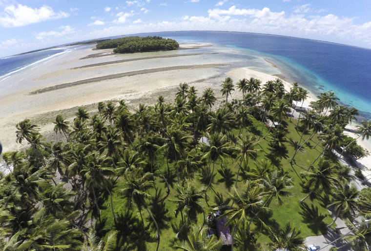 ASSOCIATED PRESS
                                This Nov. 6, 2015, file photo, shows a large section of land between the trees washed away due to continuing rising sea leaves on Majuro Atoll, Marshall Islands.