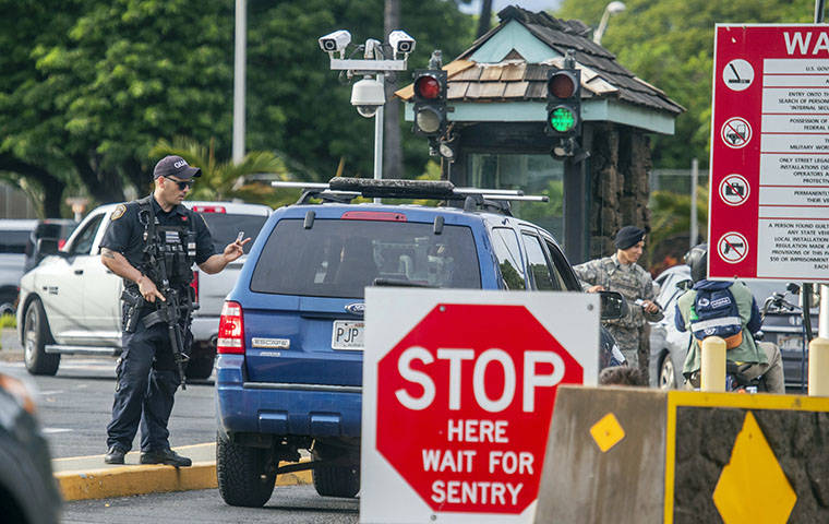DENNIS ODA / DODA@STARADVERTISER.COM
                                Security personnel guarded the Pearl Harbor main gate, Wednesday, and temporarily shut all access after an active duty sailor on the attack submarine USS Columbia opened fire near Dry Dock 2. The family of one of the men killed has identified him.