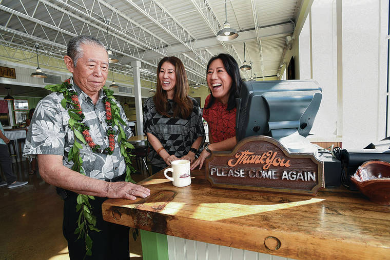 BRUCE ASATO / BASATO@STARADVERTISER.COM
                                The hostess stand at the new restaurant was built out of a butcher block from the old one. Bobby Toguchi, below left, retired owner, and his daughters — Monica, center, who now runs the business, and Regina Toguchi — recalled the many blocks of aku and bundles of laulau prepared on the block. Also carried over is the “Please Come Again” sign. Bobby Toguchi said both were left behind by the previous Leoku occupant, Bill’s Fish and Chips.