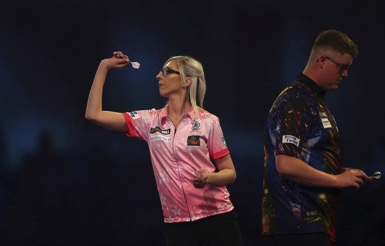 ASSOCIATED PRESS
                                Fallon Sherrock and Ted Evetts in action at the PDC Darts World Championship at Alexandra Palace, London, on Tuesday. Sherrock become the first female player to beat a man at the PDC World Championship after she recovered from losing the opening set to beat Ted Evetts 3-2 in front of a raucous crowd at Alexandra Palace.
