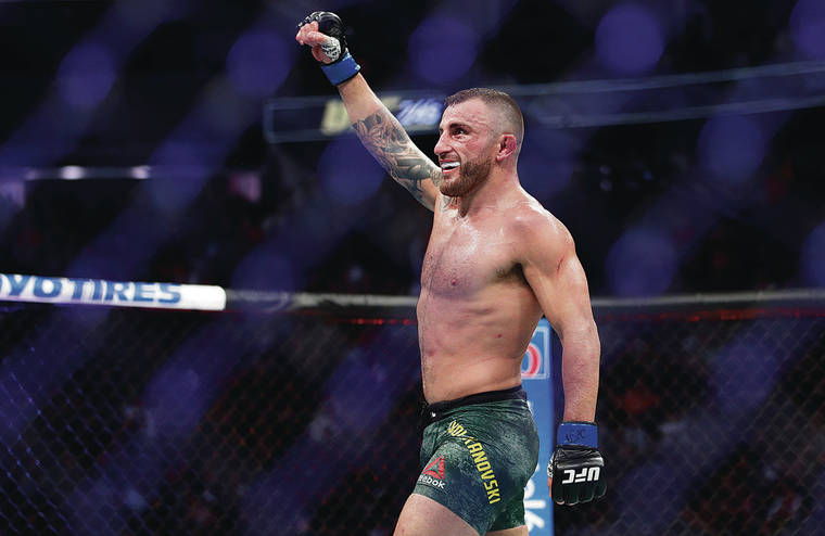 ASSOCIATED PRESS
                                Alexander Volkanovski raised his fist in triumph after the final bell in Saturday’s title bout with Max Holloway.