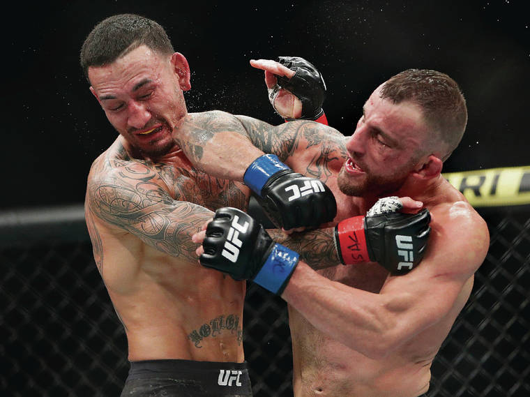 ASSOCIATED PRESS
                                Alexander Volkanovski landed an elbow against Max Holloway in the featherweight championship bout at UFC 245 on Saturday in Las Vegas. Volkanovski claimed the title by unanimous decision.