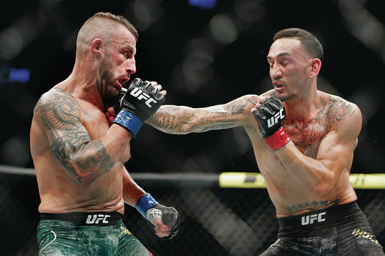 ASSOCIATED PRESS
                                Max Holloway landed a blow against Alexander Volkanovski in Saturday’s featherweight championship bout at UFC 245 in Las Vegas.