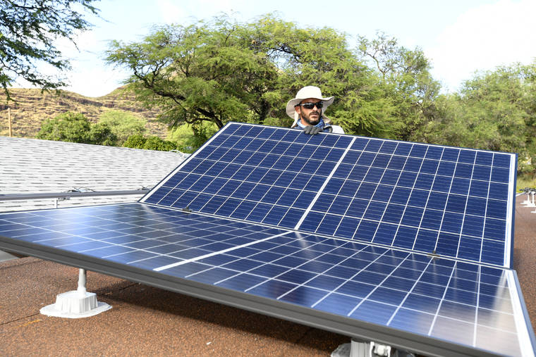 BRUCE ASATO / BASATO@STARADVERTISER.COM
                                A family in Waianae has solar panels installed at its home.