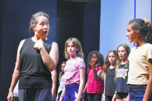 MEGAN MOSELEY / SPECIAL TO THE STAR-ADVERTISER
                                Choreographer Camille Romero works with participants during auditions for “Matilda, the Musical” at Iao Theater in Wailuku.