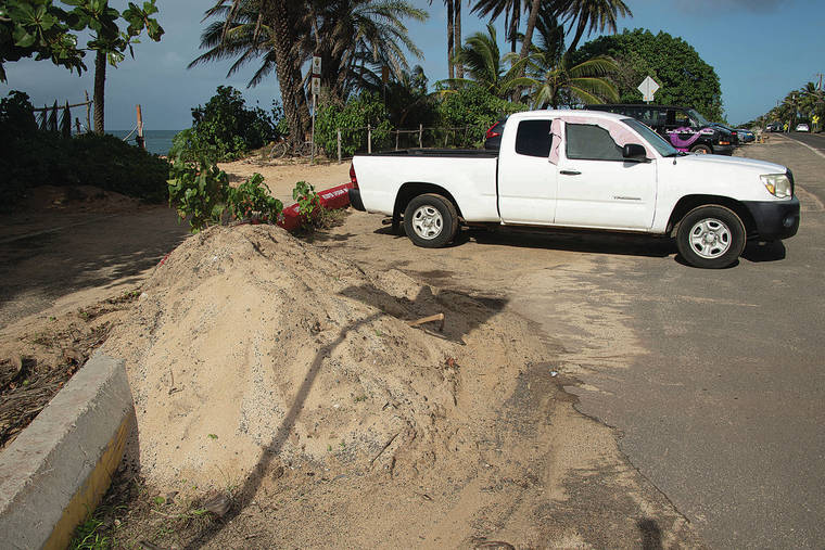 CRAIG T. KOJIMA /CKOJIMA@STARADVERTISER.COM
                                A pile of sand is excavated Monday from Sunset beach park.