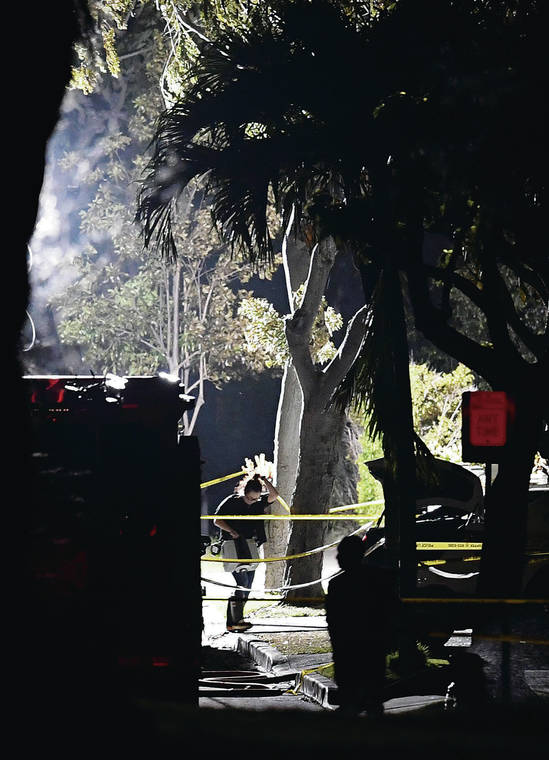 BRUCE ASATO / BASATO@STARADVERTISER.COM
                                Investigators used a floodlight that illuminated the scene of the fatal shooting on Hibiscus Drive as they continued to investigate through Sunday night.