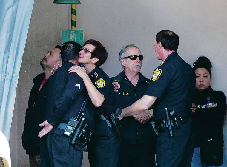 CINDY ELLEN RUSSELL / CRUSSELL@STARADVERTISER.COM
                                HPD Chief Susan Ballard embraced an officer as Deputy Chief of Police John McCarthy shook hands with another at the emergency room entrance of The Queen’s Medical Center on Sunday after the shooting at Diamond Head.