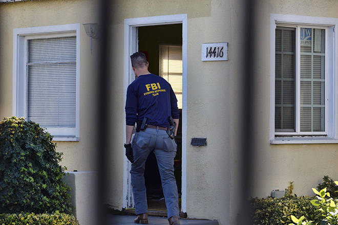 ASSOCIATED PRESS
                                An FBI evidence response team agent enters a building on the grounds of the Kingdom of Jesus Christ Church in the Van Nuys section of Los Angeles today. The FBI raided a Philippines-based church in Los Angeles to arrest leaders of an alleged immigration fraud scheme that resulted in sham marriages.