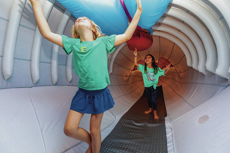 BRYAN BERKOWITZ / SPECIAL TO THE STAR-ADVERTISER
                                Kids explore the inside of a life-size inflatable humpback whale model presented at the Marine Science Center by the Hawaiian Islands Humpback Whale National Marine Sanctuary.
