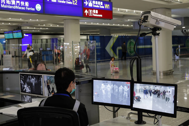 ASSOCIATED PRESS
                                A health surveillance officer monitored passengers arriving at the Hong Kong International airport on Jan. 4. A preliminary investigation into viral pneumonia illnesses sickening dozens of people in and around China has identified the possible cause as a new type of coronavirus, state media said Thursday.