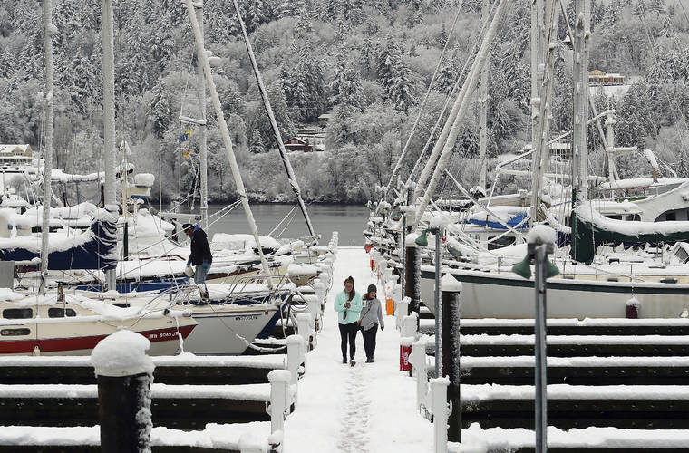 ASSOCIATED PRESS
                                Abbie Brown and Mallory Burns stroll along the snow-covered dock at the Poulsbo Marina in Poulsbo, Wash., today.