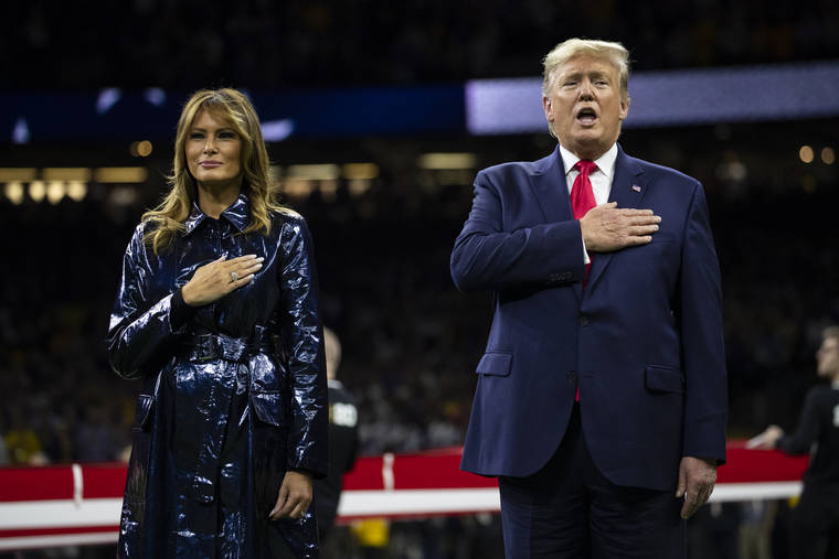 ASSOCIATED PRESS
                                President Donald Trump and first lady Melania Trump stand for the national anthem before the beginning of the College Football Playoff National Championship game between LSU and Clemson, today in New Orleans.