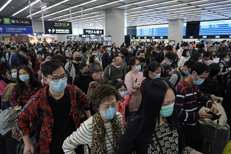 ASSOCIATED PRESS
                                Passengers wore protective face masks, Thursday, at the departure hall of the high-speed train station in Hong Kong. Chinese authorities Thursday moved to lock down three cities that are home to more than 18 million people in an unprecedented effort to contain the deadly new virus that has sickened hundreds and spread to other parts of the world during the busy Lunar New Year travel period.