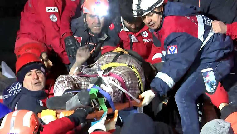 IHA VIA AP
                                Rescue workers carry a wounded person after they rescued him from the debris of a collapsed building following a strong earthquake in Elazig in the eastern Turkey. The earthquake rocked eastern Turkey on Friday, causing some buildings to collapse and killing scores of people, Turkish officials said.