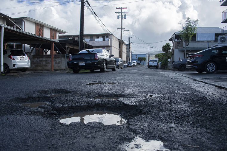 STAR-ADVERTISER / OCT. 2019
                                State Department of Transportation crews on Monday delivered two to three tons of asphalt patch material to maintenance base yards to continue patching pot holes on state roads around Oahu through the rest of the week. Rainwater gathered in potholes on Factory Street in Kalihi.