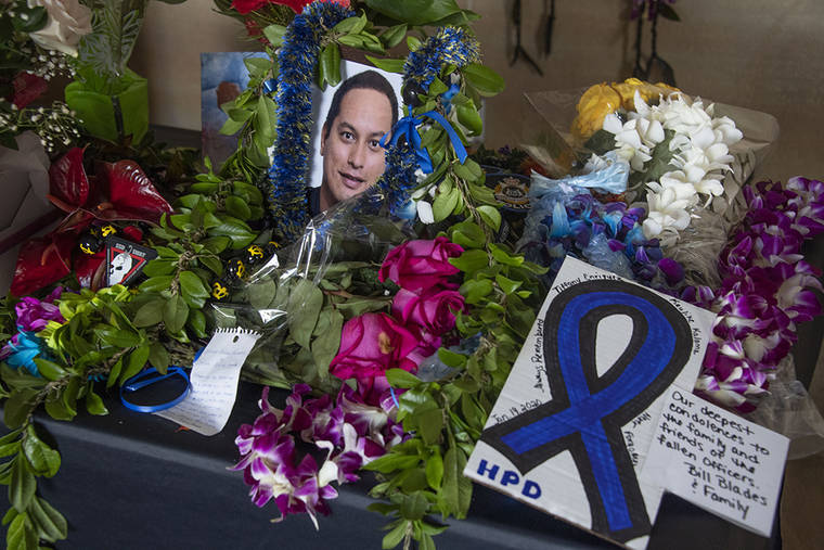 CRAIG T. KOJIMA / CKOJIMA@STARADVERTISER.COM
                                A growing array of orchid lei, ti leaves, roses and maile lei is seen below Honolulu Police Department’s “Roll of Honor” plaque featuring the names of Tiffany Enriquez and Kaulike Kalama, pictured.