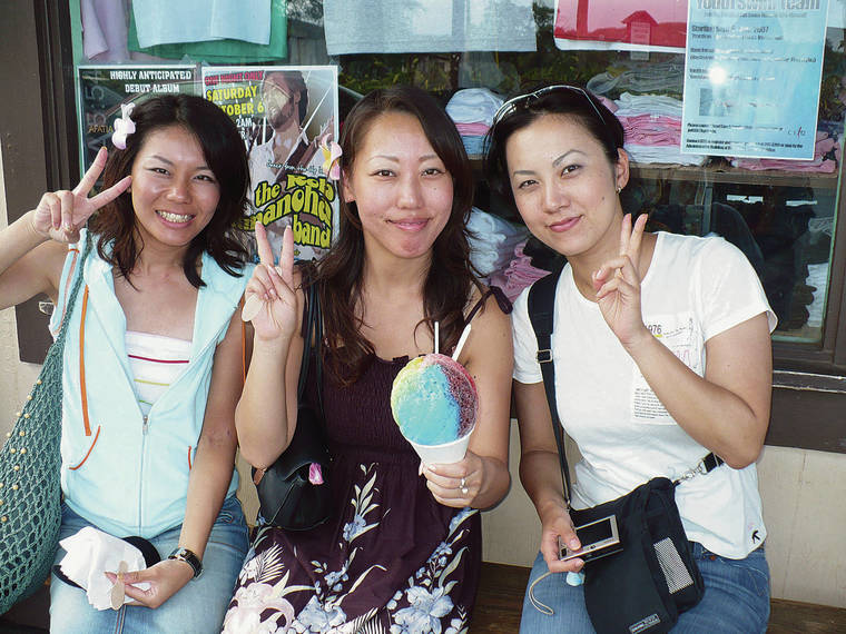 COURTESY BOB SIGALL Shave ice is a Hawaii favorite but on the Big Island it is known as “ice shave.” Three visitors partake at Matsumoto Shave Ice on the North Shore.