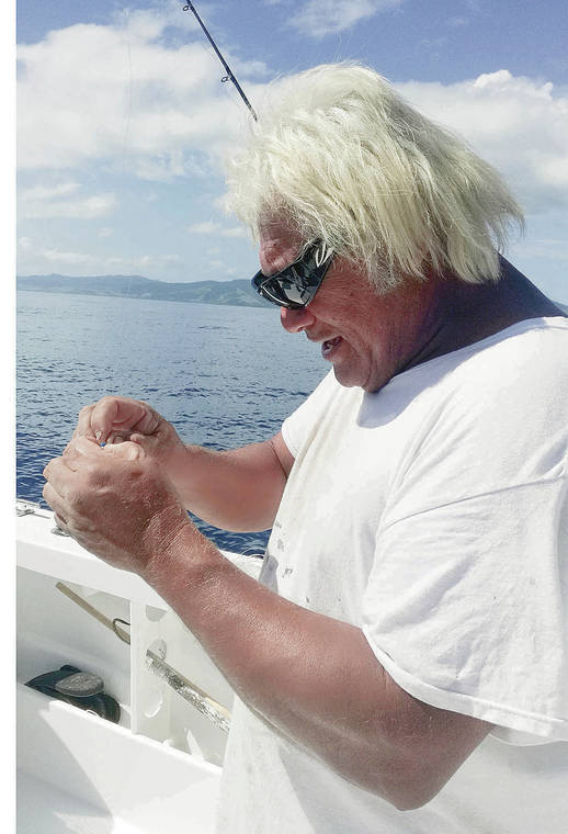 Captain John Llanes repairs his tackle; sashimi from a skipjack tuna prepared at Rosie’s at at Makaira Resort.