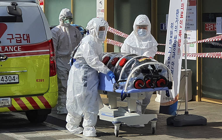 KIM JONG-UN/YONHAP VIA ASSOCIATED PRESS
                                Medical workers wearing protective gear moved a patient suspected of contracting the new coronavirus, Wednesday, from an ambulance to the Kyungpook National University Hospital in Daegu, South Korea.