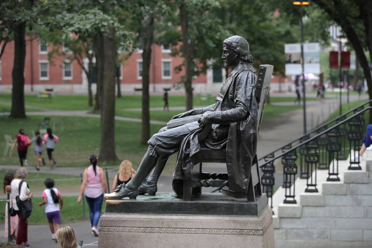 ASSOCIATED PRESS / 2019
                                The statue of John Harvard sits in Harvard Yard at Harvard University in Cambridge, Mass.