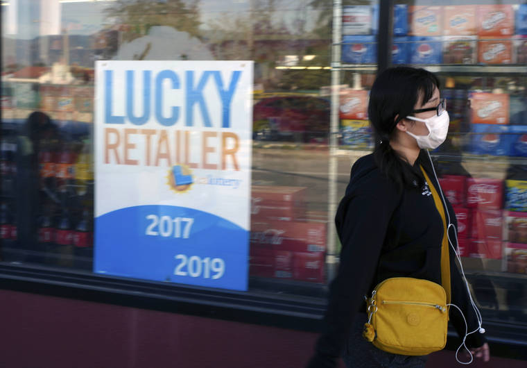 A pedestrian wears a protective mask in Alhambra, Calif., on Friday. As China grapples with the growing coronavirus outbreak, Chinese people in the Los Angeles area, home to the third-largest Chinese immigrant population in the United States, are encountering a cultural disconnect as they brace for a possible spread of the virus in their adopted homeland.