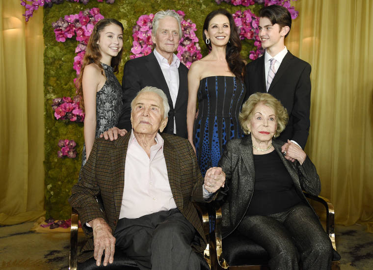 Chris Pizzello/Invision/AP / 2016
                                Actor Kirk Douglas, seated left, holding hands with his wife Anne Douglas, seated right, as they pose with family members, their son Michael, standing second left, his wife Catherine Zeta-Jones, standing second and their children, Carys, left, and son Dylan during Kirk’s 100th birthday party in Beverly Hills, Calif. Kirk Douglas died Wednesday, Feb. 5, 2020 at age 103.