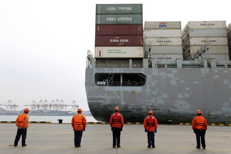 CHINATOPIX VIA AP / FEB. 4
                                Workers watch a container ship arrive at a port in Qingdao in east China’s Shandong province. Factories across China are still closed to try to limit spread of the coronavirus, leaving business owners in limbo.
