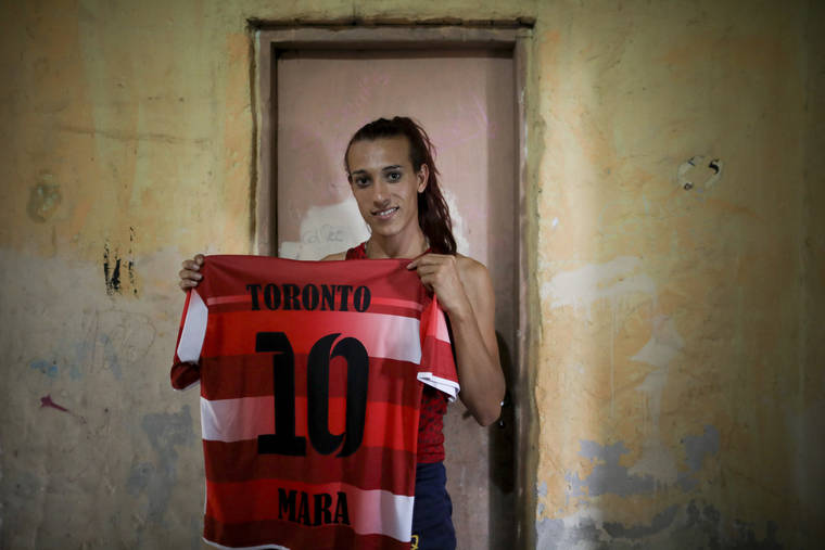 ASSOCIATED PRESS / FEB. 6
                                Soccer player Mara Gomez poses with her old jersey from the first amateur soccer club she played for, Toronto, in La Plata, Argentina. Gomez is a transgender woman who is limited to only training with her women’s professional soccer team, Villa San Carlos, while she waits for permission to start playing from the Argentina Football Association (AFA). If approved, she would become the first trans woman to compete in a first division, professional Argentine AFA tournament.