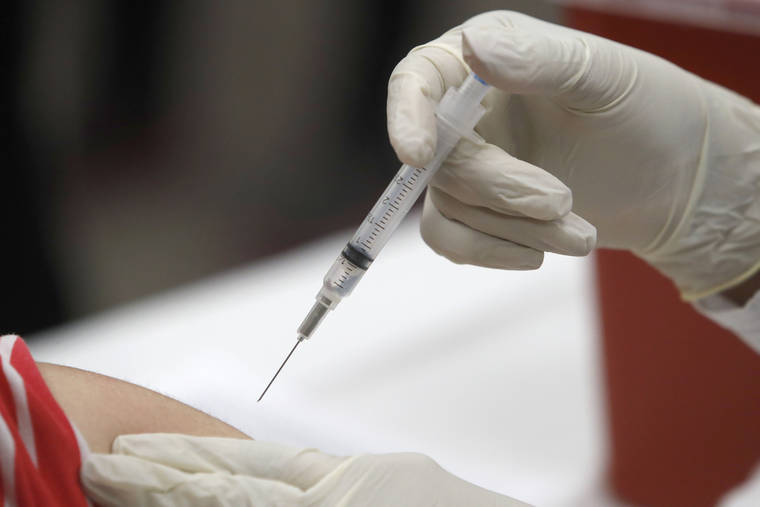 ASSOCIATED PRESS / JAN. 23
                                A syringe with influenza vaccine inside heads for its mark during a flu vaccination at Eastfield College in Mesquite, Texas. A second wave of flu is hitting the U.S., turning this season into one of the nastiest flu seasons for kids in a decade.
