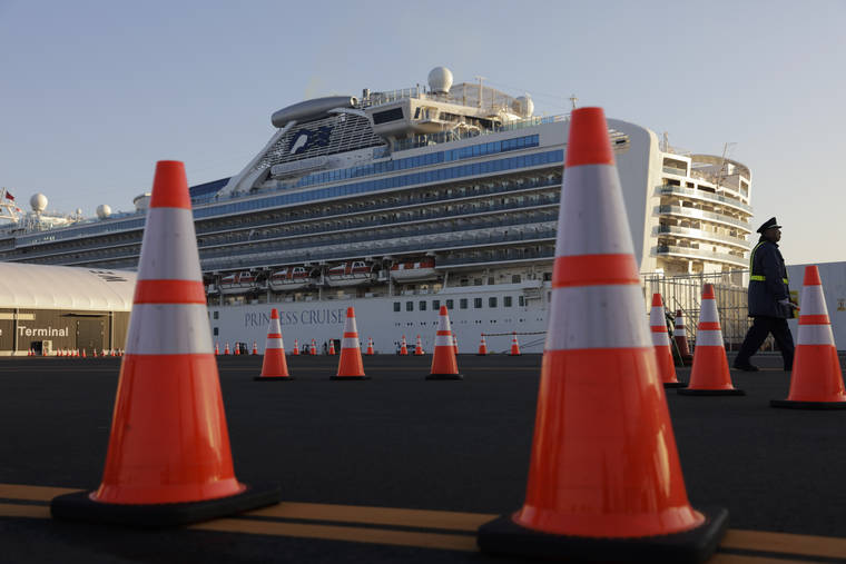 ASSOCIATED PRESS
                                A security guard stood near the quarantined Diamond Princess cruise ship, Feb. 13, in Yokohama, near Tokyo. After 14 days, an extraordinary quarantine of the Diamond Princess cruise ship ends Wednesday, with thousands of passengers and crew set to disembark over the next several days in the port of Yokohama.