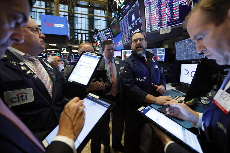ASSOCIATED PRESS
                                Traders gather on the floor of the New York Stock Exchange today.