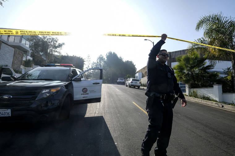 ASSOCIATED PRESS
                                A police officer guarded outside a Hollywood Hills home where a fatal shooting occurred, today, in Los Angeles.