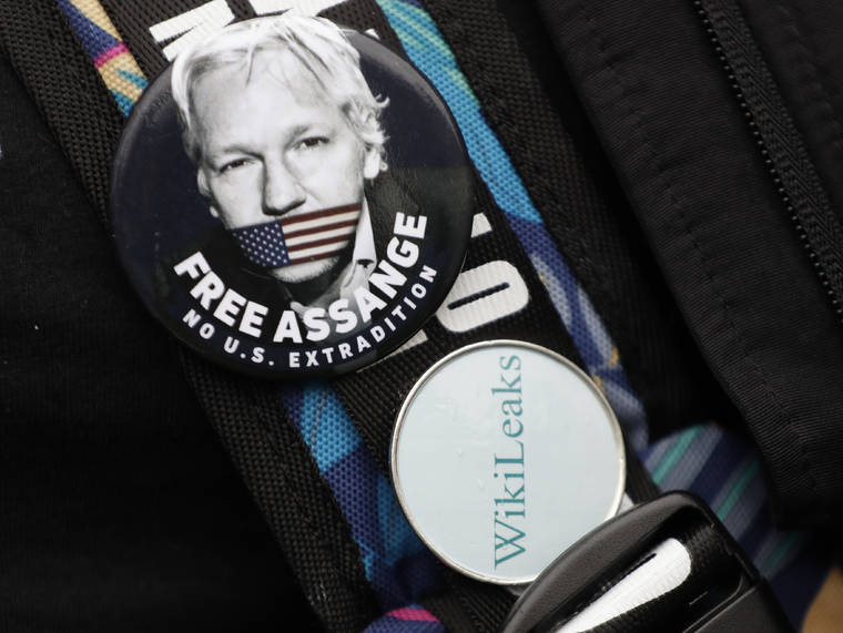 ASSOCIATED PRESS
                                A demonstrator wore badges supporting Julian Assange outside Westminster Magistrates Court in London today.