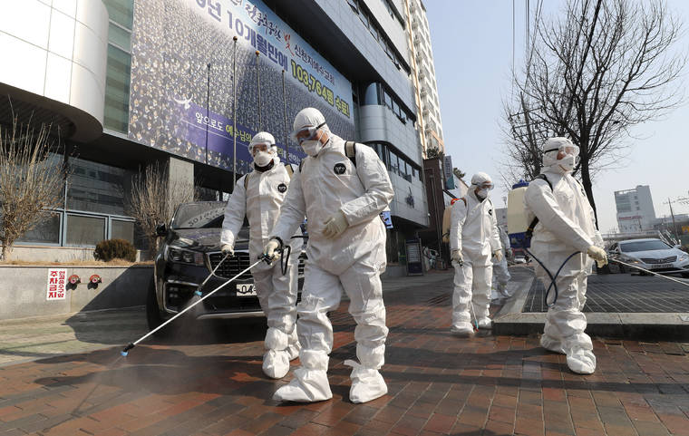 YONHAP VIA ASSOCIATED PRESS
                                Workers wearing protective gear sprayed disinfectant against the new coronavirus in front of a church in Daegu, South Korea, Thursday.