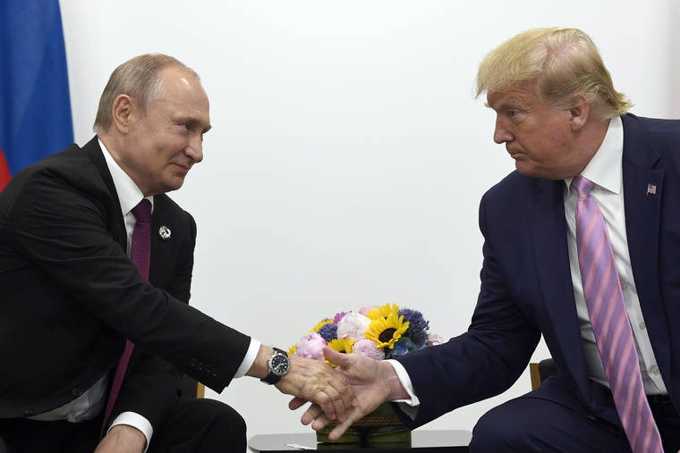 ASSOCIATED PRESS
                                President Donald Trump, right, shook hands with Russian President Vladimir Putin, left, during a bilateral meeting, June 28, on the sidelines of the G-20 summit in Osaka, Japan. Intelligence officials have warned lawmakers that Russia is interfering in the 2020 election campaign to help President Donald Trump get reelected, according to three officials familiar with the closed-door briefing.