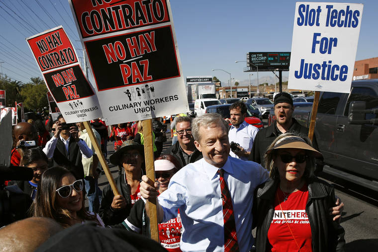 ASSOCIATED PRESS
                                Democratic presidential candidate, businessman Tom Steyer walks on a picket line with members of the Culinary Workers Union Local 226 outside the Palms Casino in Las Vegas on Wednesday.