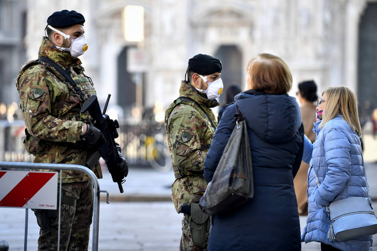 CLAUDIO FURLAN/LAPRESSE VIA ASSOCIATED PRESS
                                Italian soldiers wearing sanitary masks patrolled Duomo square in downtown Milan, Italy, Monday. At least 190 people in Italy’s north have tested positive for the COVID-19 virus and four people have died, including an 84-year-old man who died overnight in Bergamo, the Lombardy regional government reported.