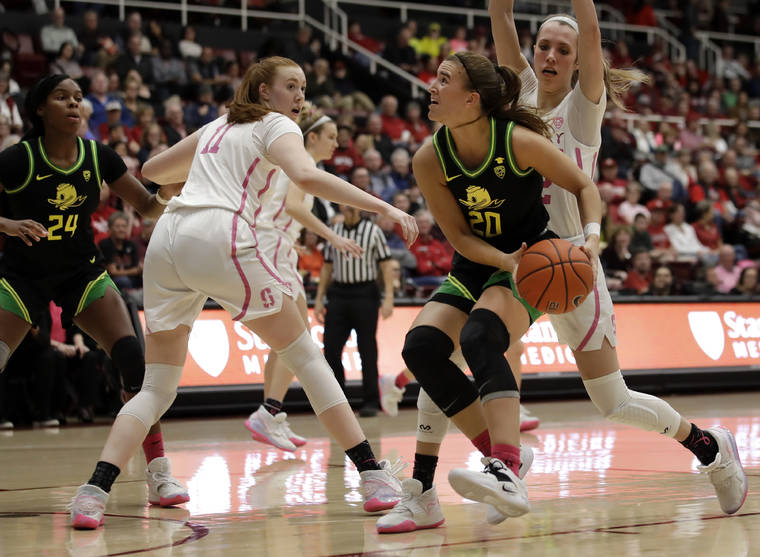 ASSOCIATED PRESS
                                Oregon’s Sabrina Ionescu looks to shoot between Stanford’s Ashten Prechtel (11) and Lexie Hull, right, in the first half.