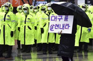 NEWSIS VIA ASSOCIATED PRESS
                                A protester holds a sign to denounce government’s coronavirus responses in Daegu, South Korea, Tuesday.