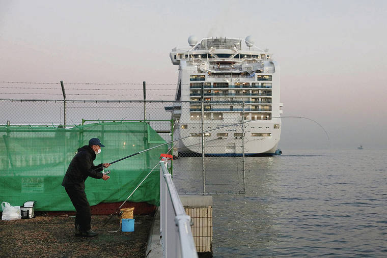ASSOCIATED PRESS 
                                A man fished behind the quarantined Diamond Princess cruise ship Thursday.