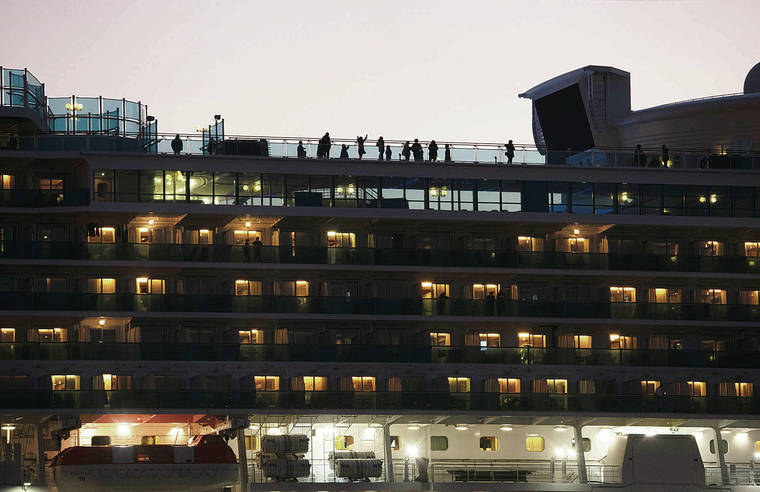 ASSOCIATED PRESS 
                                Tourists quarantined on the Diamond Princess cruise ship got some fresh air on the top deck of the ship Thursday in Yokohama, near Tokyo.