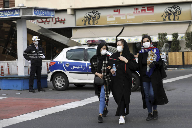 ASSOCIATED PRESS                                A policeman and pedestrians wear masks to help guard against the coronavirus in Tehran, Iran, on Sunday.