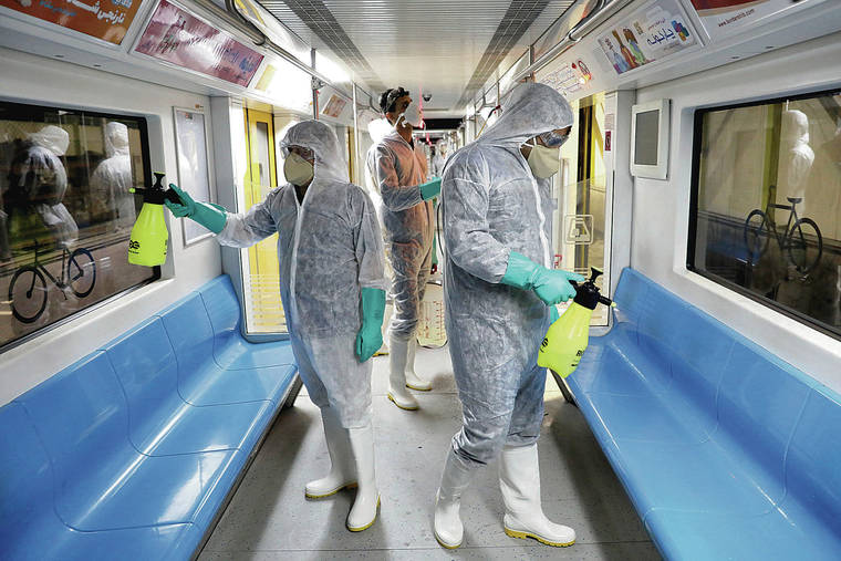 ASSOCIATED PRESS
                                Governments around the world are scrambling to cope with or prepare for COVID-19. Above, workers disinfected subway trains against coronavirus in Tehran, Iran, early this morning.