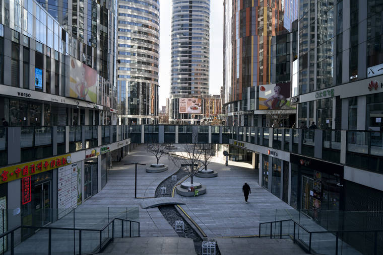 NEW YORK TIMES
                                Sanlitun Soho, a usually busy office complex, is nearly deserted in Beijing on Feb. 1, 2020. The Chinese capital, like other cities far from the epidemic’s center, has imposed restrictions and shut down public spaces, straining the ties that bind society.