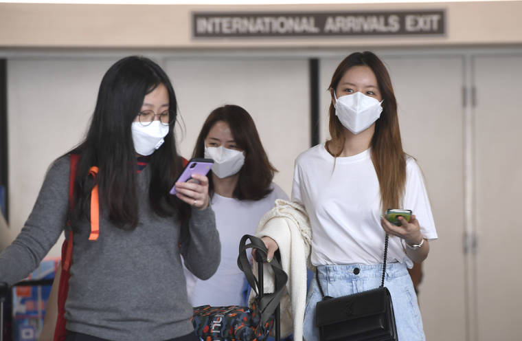 BRUCE ASATO / BASATO@STARADVERTISER.COM
                                Airline travelers from Asia make their way from the international arrivals customs area at the Daniel K. Inouye International Airport on Sunday.