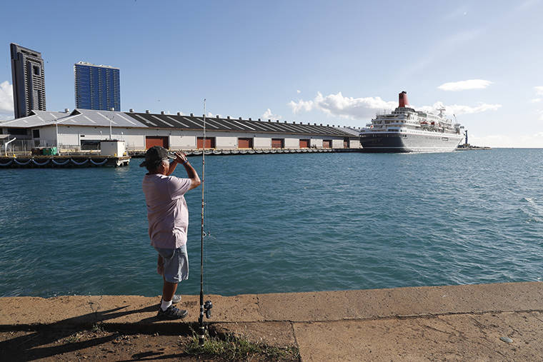 CINDY ELLEN RUSSELL / CRUSSELL@STARADVERTISER.COM
                                A fisherman looks towards the Nippon Maru docked at Pier 2 in Honolulu today.