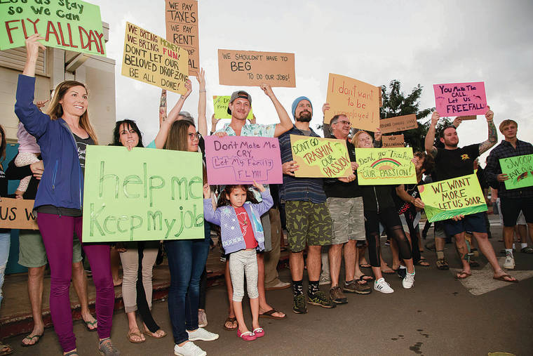 KAT WADE / SPECIAL TO THE STAR-ADVERTISER
                                Many Skydiving Hawaii employees turned out Tuesday to support the Dillingham Airfield before and during the North Shore town hall meeting.